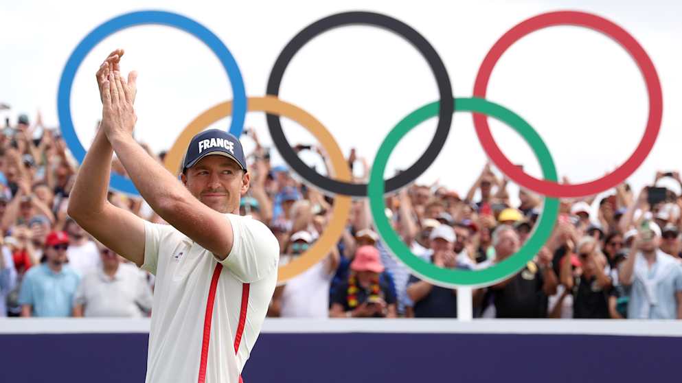 For France! Victor Perez appreciates the reception from the crowds on the first tee